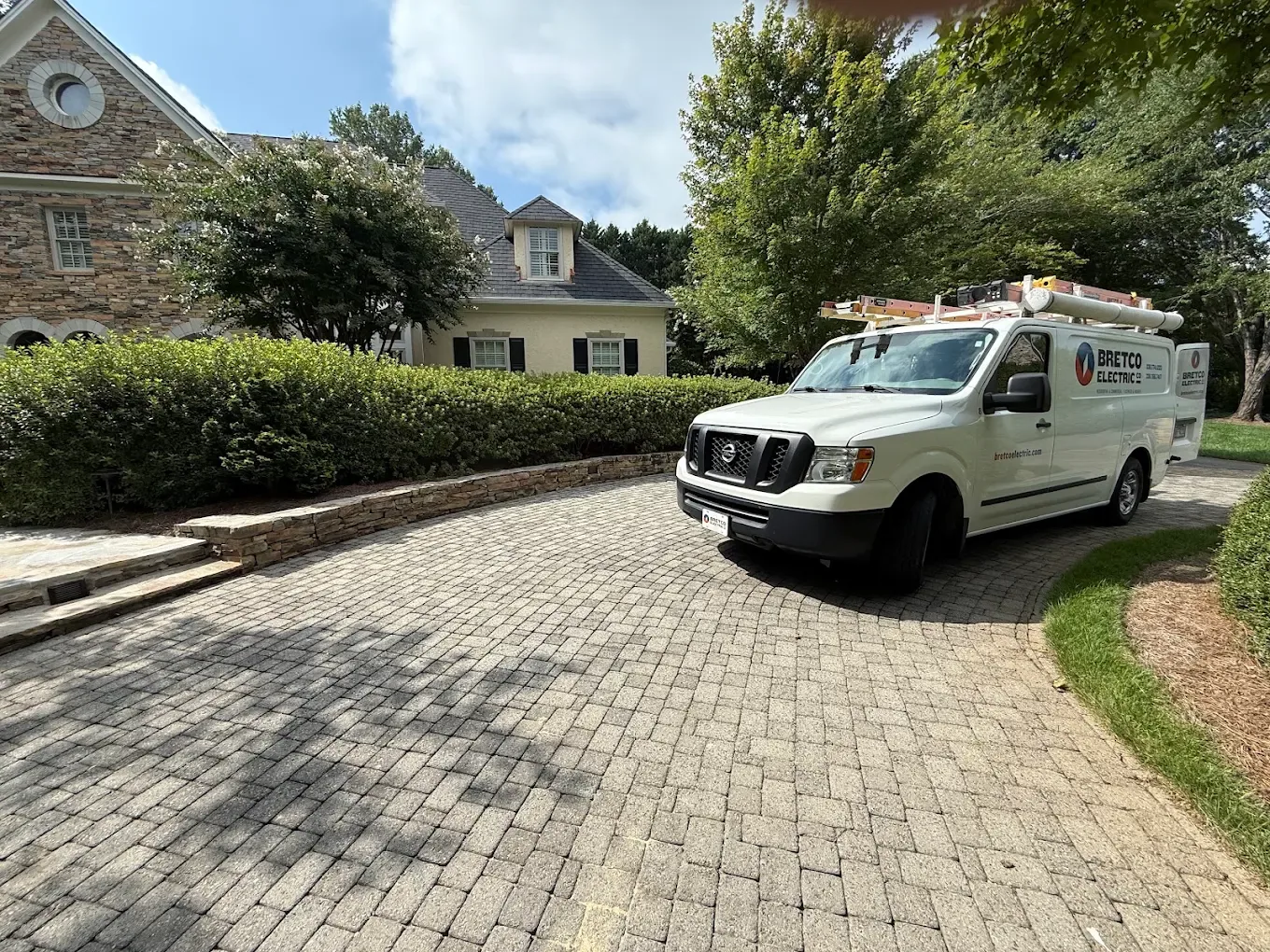 Bretco Electric van front view paver driveway stucco house