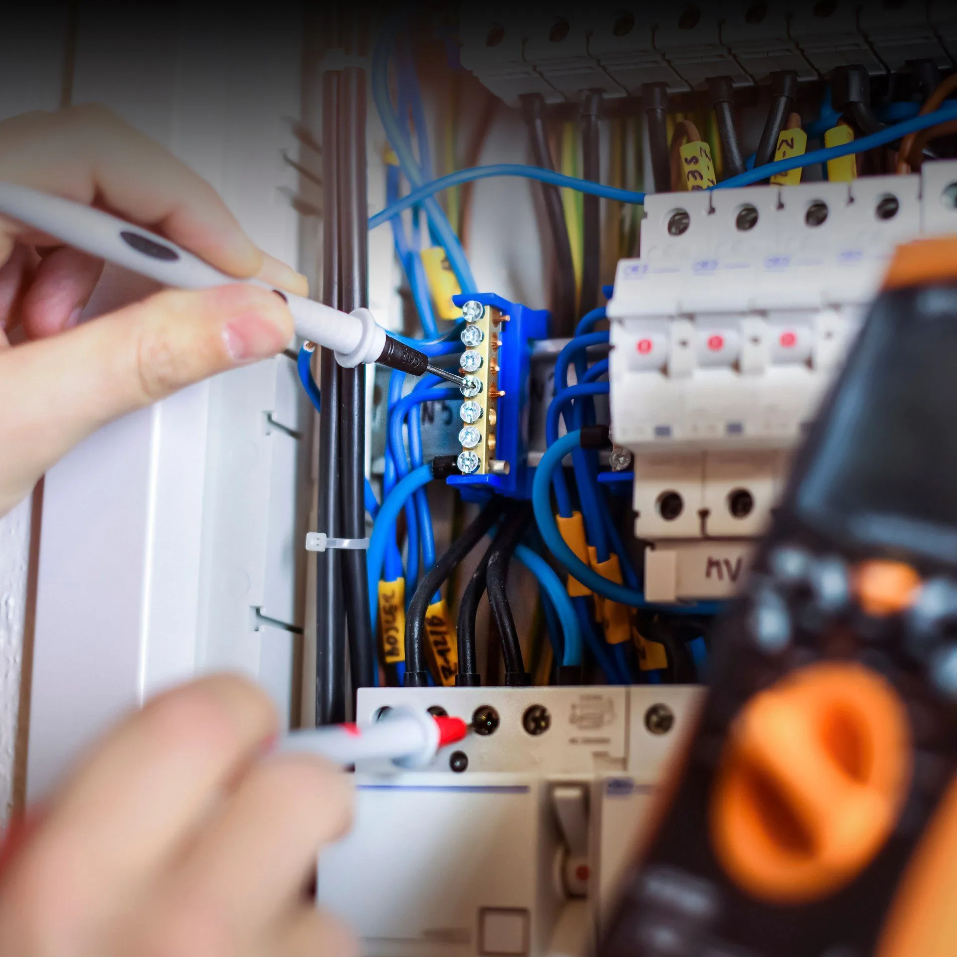 Electrician multimeter testing breaker panel