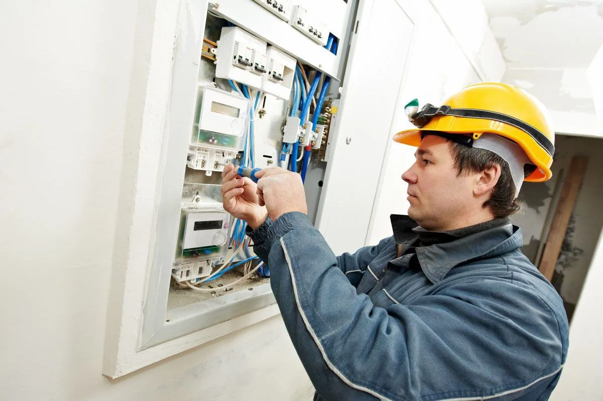 Hard hat electrician screwdriver electric meter panel