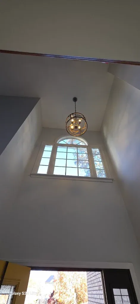 Orb sphere chandelier two story foyer arched window
